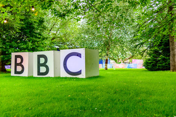 large bbc sign in park with grass and trees