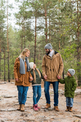 family walking by forest together