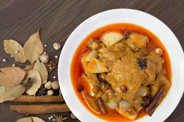 Mussaman curry chicken in white bowl with spices and herbs  / Halal food and selective focus..