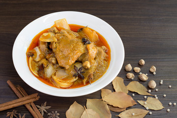 Mussaman curry chicken in white bowl with spices and herbs  / Halal food and selective focus..