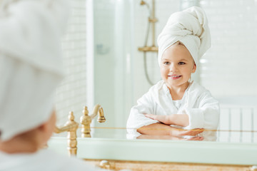 kid in bathrobe and towel on head