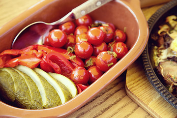 Pickled tomatoes  and cucumbers  with bowl