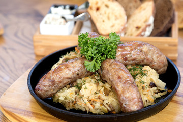 Sauerkraut with home-made sausage on a frying pan