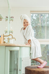 kid in bathrobe and towel on head