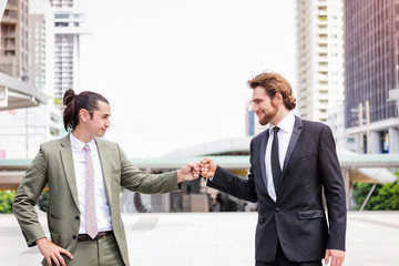 Business people with a Partnership Team Giving Fist Bump after complete deal. Successful Teamwork Partnership in an Office concept.