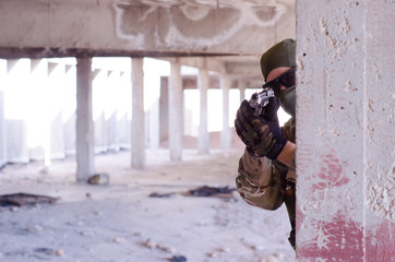 Soldier take cover with on wall aim camera with hand gun