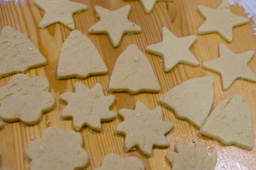 Gingerbread Christmas cookies, on a kitchen table, glazed with chocolate and sprinkled with powdered sugar, diffrent shapes. Concept Christmas.