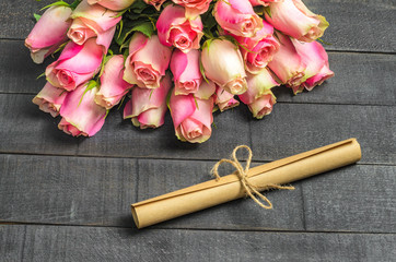 Bouquet of roses and letter scroll