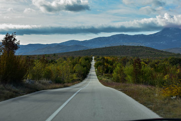 Long open road through beautiful countryside 