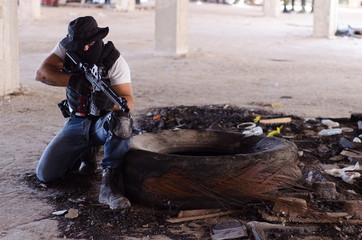 Soldier On Knee position burning car tires