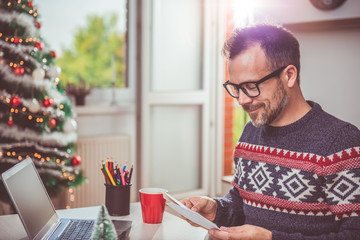 Men opening christmas letter