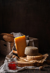 Dark still life with cheese and bread