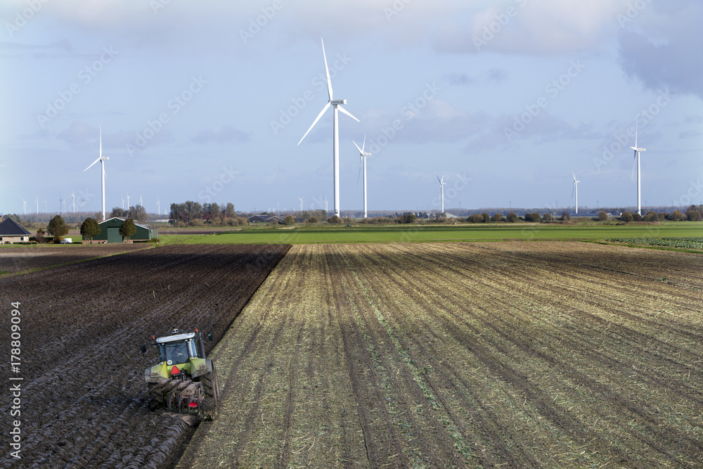 Canvas Prints tractor and plow at work on field in the dutch province of flevoland in the netherlands