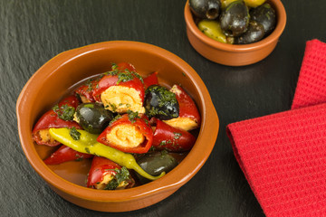 different antipasti with olives and chili peppers