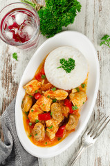Chicken stew with mushrooms served  with rice