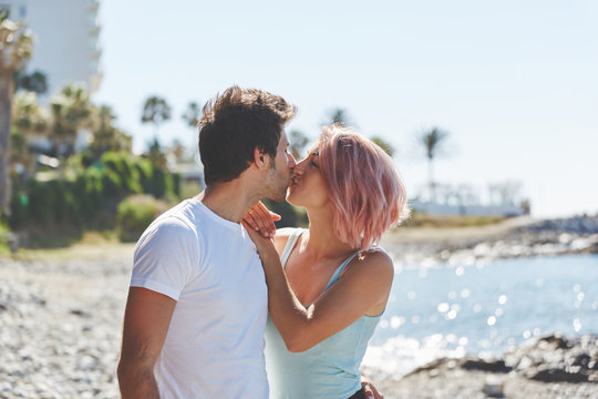 Happy couple kissing each other on beach