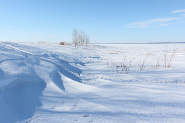 Fototapeta na wymiar Snow island on the river in winter, Khrenovy Island, Reservoir on the Ob river, Siberia, Russia