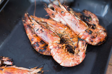 Grilled shrimps on tray background