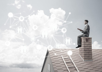 Man on roof reading book and concept of social connection