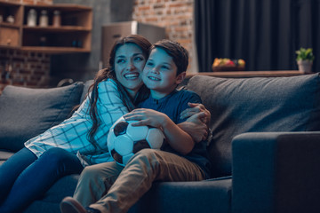 Hugging mother and son watching soccer © LIGHTFIELD STUDIOS