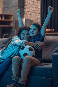 Hugging Mother And Son Watching Soccer