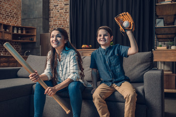Cheering family watching baseball on couch