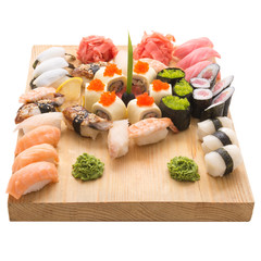 Sushi rolls served on a wooden plate in a restaurant