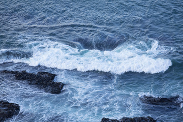 Fototapeta premium Waves Washing Over Rocks at Beach