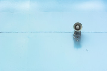 Old loud speaker on the iron wall background