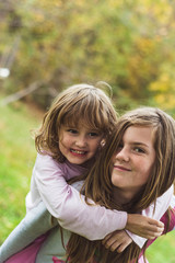 Young sisters playing together in the garden.