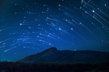 Rotating star galaxy mountain night blue sky