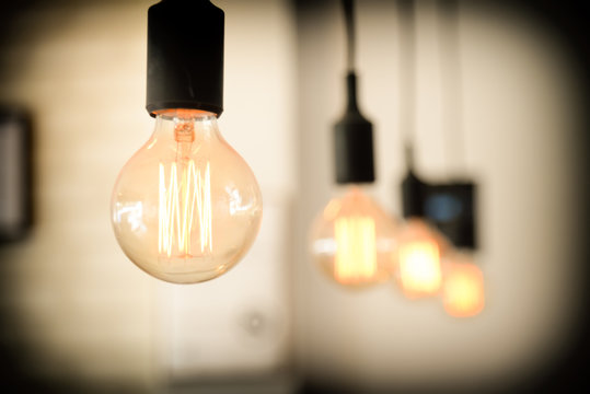 light bulbs against wall background.retro luxury light lamp glowing.Restaurant modern interior light bulbs