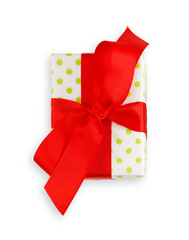 Gift box wrapped in white paper and red ribbon