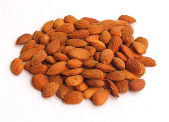 Closeup of heap of unprocessed Gurbandi Almond nut isolated on white background