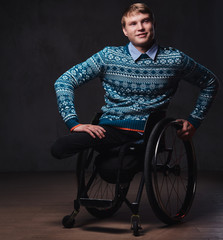 A man in wheelchair over grey background.