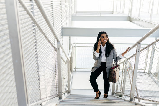 Elegant woman climbing stairs on street