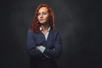 Redhead female supervisor dressed in an elegant suit.