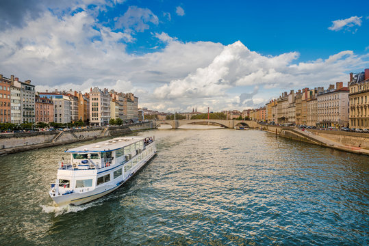 Boat moving down the Saone river in the city of Lyon, France