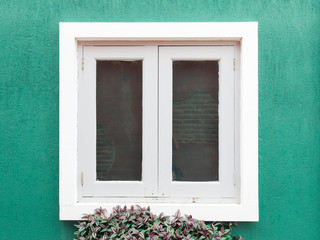 Picturesque window on green wall of house. Italy home style