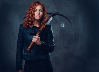 Redhead female  holds crossbow. - obrazy, fototapety, plakaty