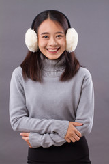happy smiling asian woman with earmuffs