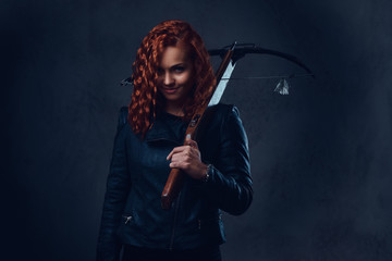 Redhead female  holds crossbow.