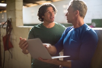 Two male friends using laptop