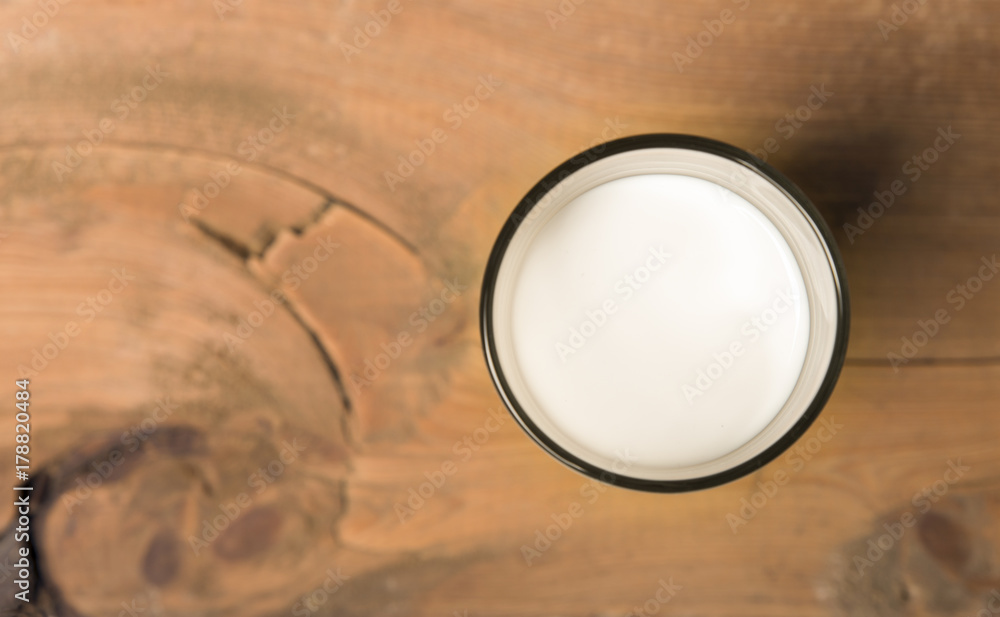 Wall mural glass of milk with straw isolated on white background. from top view