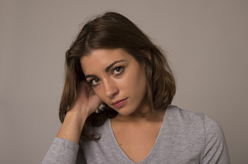 portrait of young beautiful and sweet woman looking sad and devastated in sadness emotion