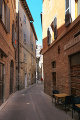 Urbino, Italy - August 9, 2017: A small street in the old town of Urbino. sunny day.