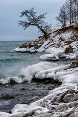 Waves and splash on Lake Baikal with rocks and trees in Uzuri bay