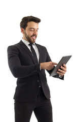 Man smiling and using tablet. Beautiful and elegant person is wearing black suit..