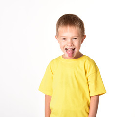 Spoiled child. The boy shows the tongue. A bad child. The education of children. The boy is on a white background.