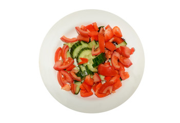 Vegetarian salad of tomatoes, cucumbers and sweet red peppers on the plate isolated on white background